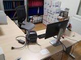 a desk with a computer monitor and a printer on it