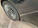 a close up of a car ' s tire on the street