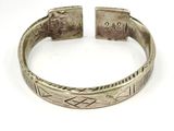 an old silver cuff bracelet with a number on it