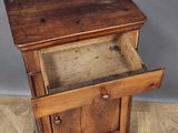 an old wooden cabinet with a drawer on top of it on a wooden floor