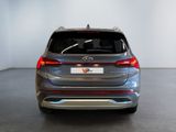 the rear end of a silver suv parked in a room