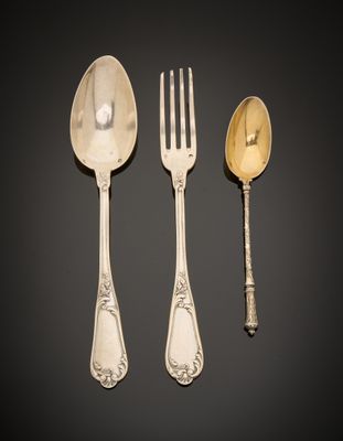 three silver spoons and a fork on a black surface