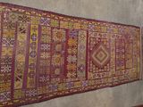 a rug hanging on a wall in a room