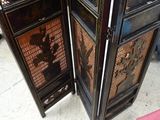 two black and gold folding screens in a room