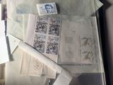 a pile of papers and stamps on a table