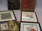 several framed and unframed pictures of flowers and birds on a table