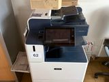 a printer sitting on top of a stack of boxes