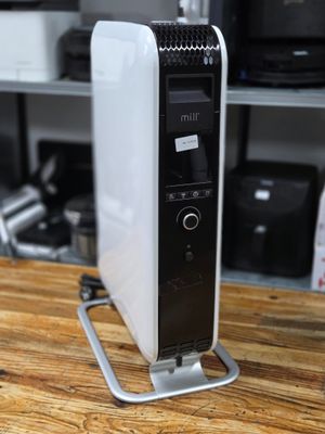 a black and white air purifier sitting on a wooden table