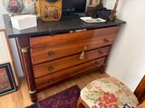 a dresser with a mirror and a vase on top of it
