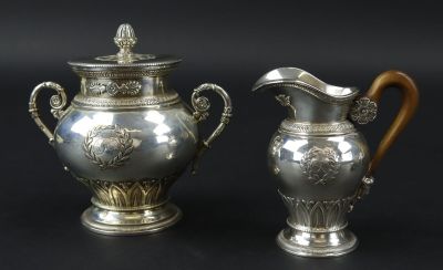 deux vases en argent posés l'un à côté de l'autre sur une table