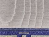 the blue wallet is sitting on the table next to the window