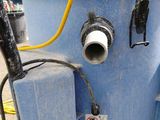 a blue water tank with a yellow hose attached to it