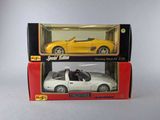 two boxes with a toy car in them on a white surface