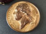 a gold coin with a picture of a woman on it