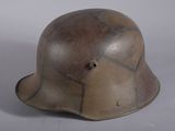 an old helmet with a hole in the middle of it