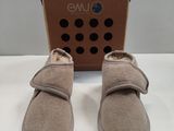 the baby ' s shoes are in front of a cardboard box