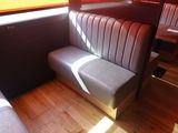 a booth with a bench and a table in it