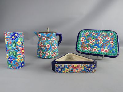 several pieces of pottery are displayed on a gray surface
