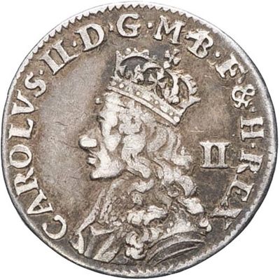 a silver coin with a crown on top of it