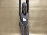 an image of a statue of a man holding a piece of wood