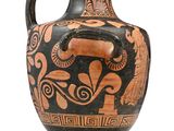 a black and orange vase with a design on it