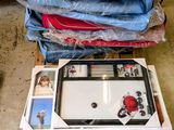 a pile of clothes on a pallet next to a refrigerator