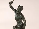bronze statue of a man with a spear and a dog on a pedestal