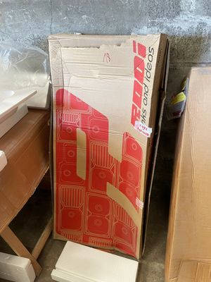 a cardboard box sitting on top of a desk next to a chair