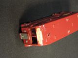 a red cell phone that is laying on a table