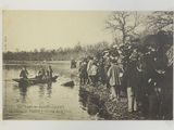 a group of people standing on the shore of a lake