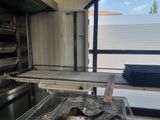 a kitchen with a large oven and a table with a towel on it