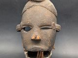 an image of a clay mask with a tooth sticking out of it ' s mouth
