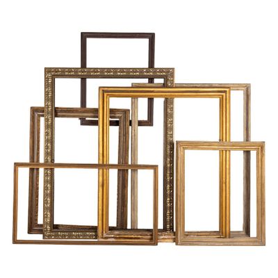 a set of five gold and black picture frames sitting on top of each other