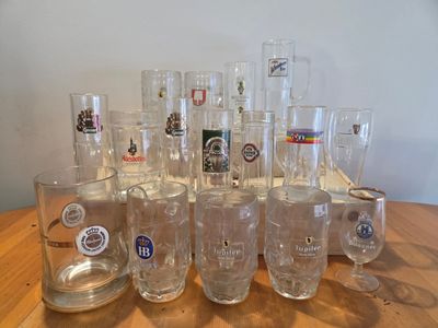 a lot of glasses sitting on a wooden table