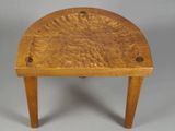 an image of a small wooden stool with holes in the top