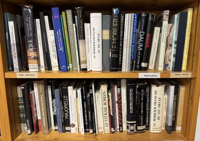 a book shelf with many books on it in a room