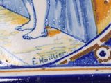 a blue and yellow tile with a picture of a woman