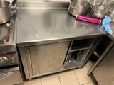 a stainless steel counter with pots and pans on it