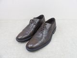une paire de chaussures marron posées sur une surface blanche