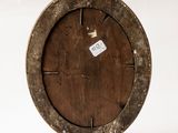 a wooden plate with a tag on it on a stand
