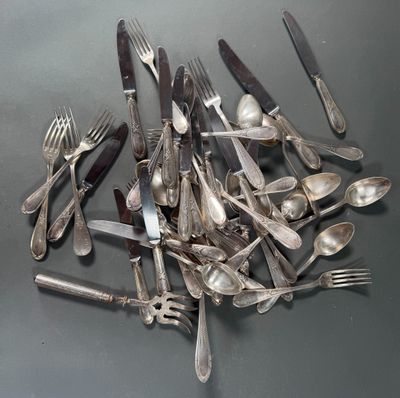 a pile of silverware on a table with forks and spoons