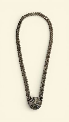 a black necklace with a spiral design on a white background