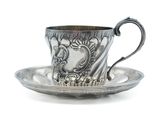 silver cup and saucer on a saucer on a white background