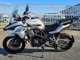 a picture of a motorcycle parked in front of a fence