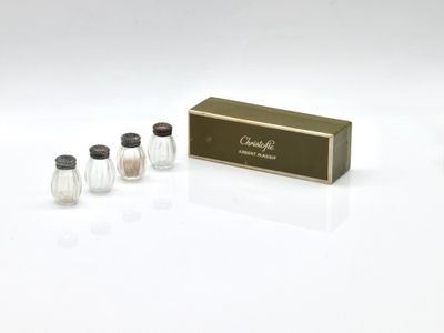 three salt and pepper shakers in a box on a white surface