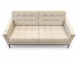 an image of a beige couch sitting on top of a white floor