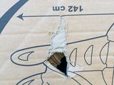a cardboard box with a drawing of a plane on it