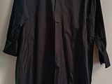 shirt hanging on a hanger on a wall in a room