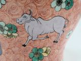a vase with a picture of a cow and flowers on it