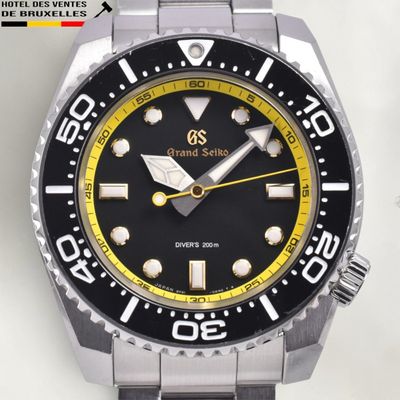 a black and yellow watch with a yellow second hand
